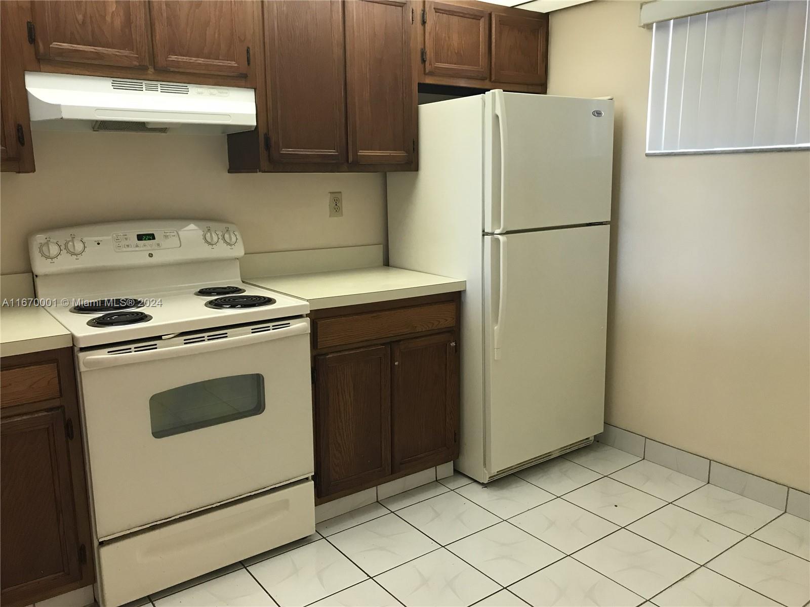 a kitchen with cabinets and white stainless steel appliances