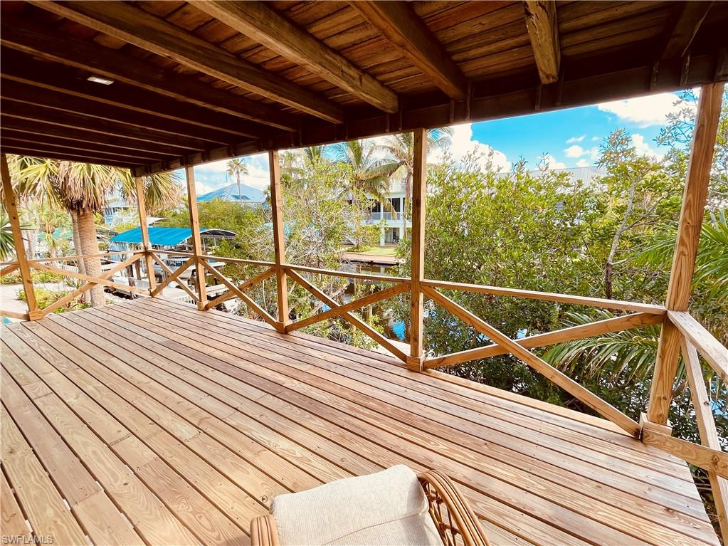 a view of a balcony with wooden floor