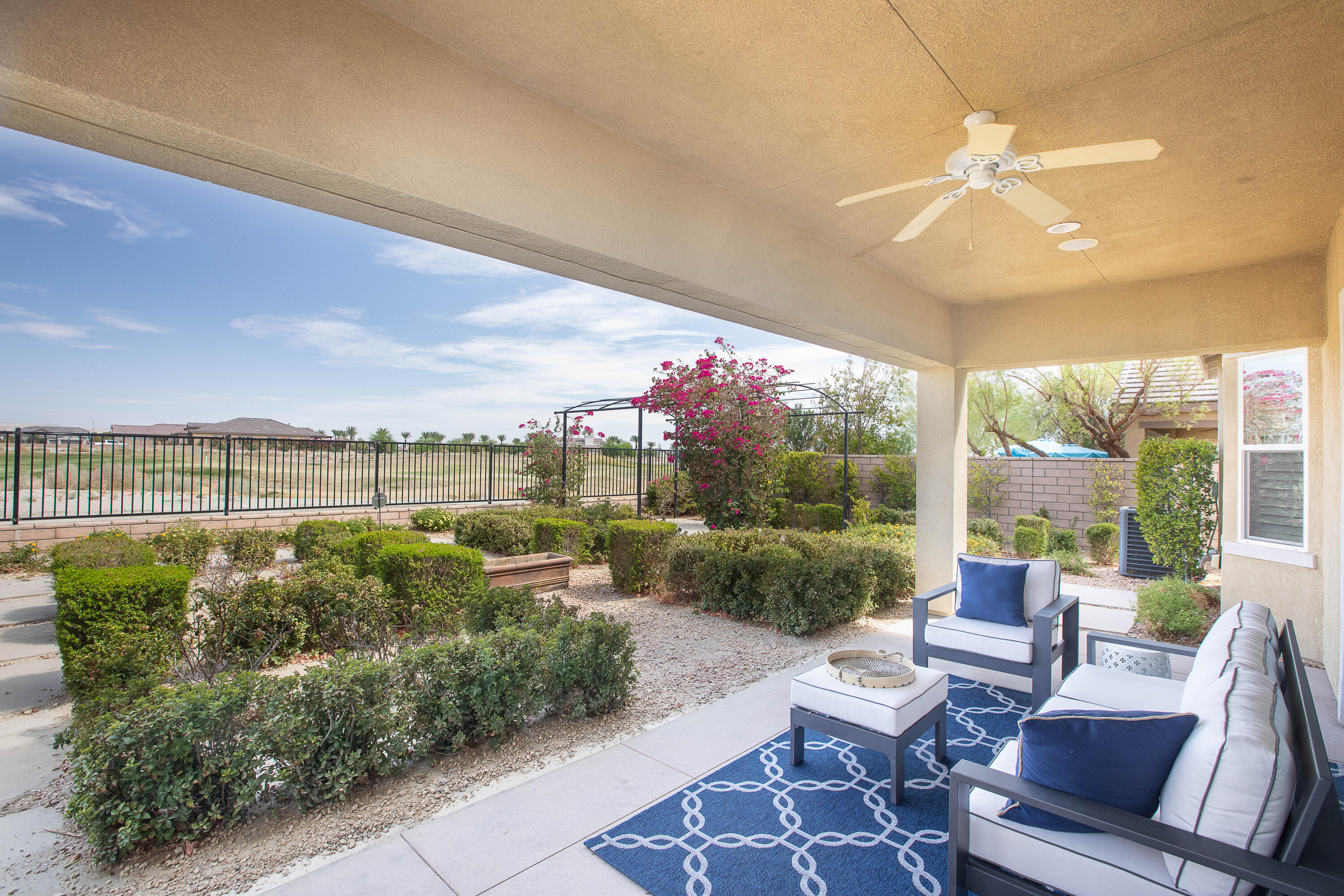 a view of a patio with couches table and chairs and potted plants