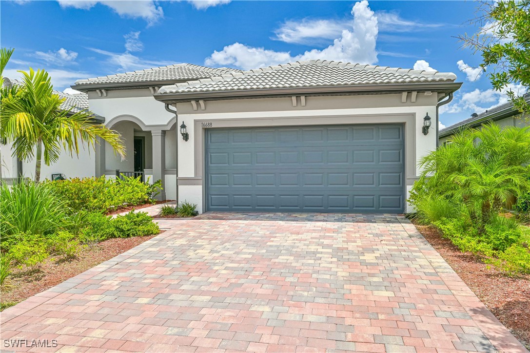 a front view of a house with a yard and garage