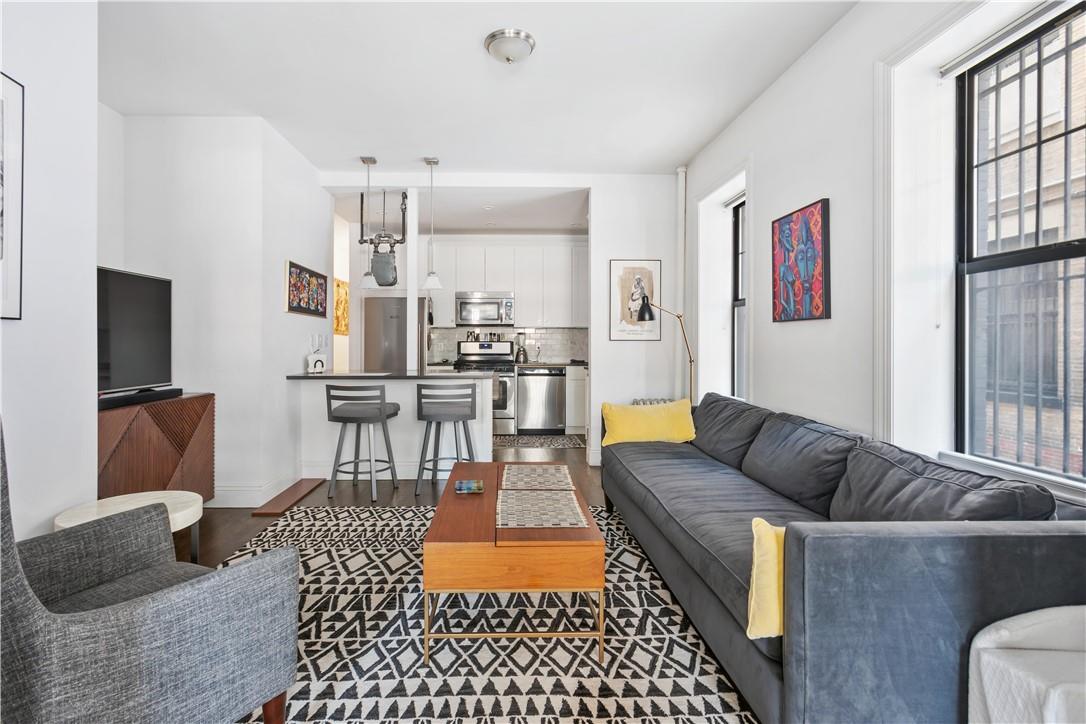 Living room with plenty of natural light and dark hardwood / wood-style floors