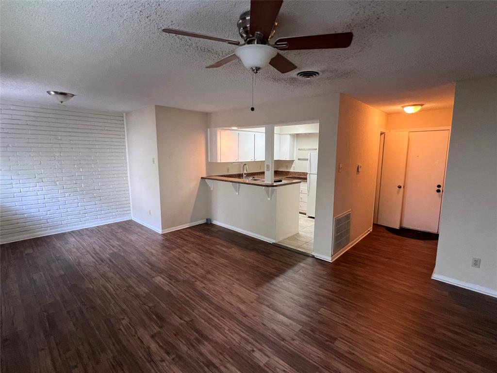 a kitchen with wooden floors and appliances