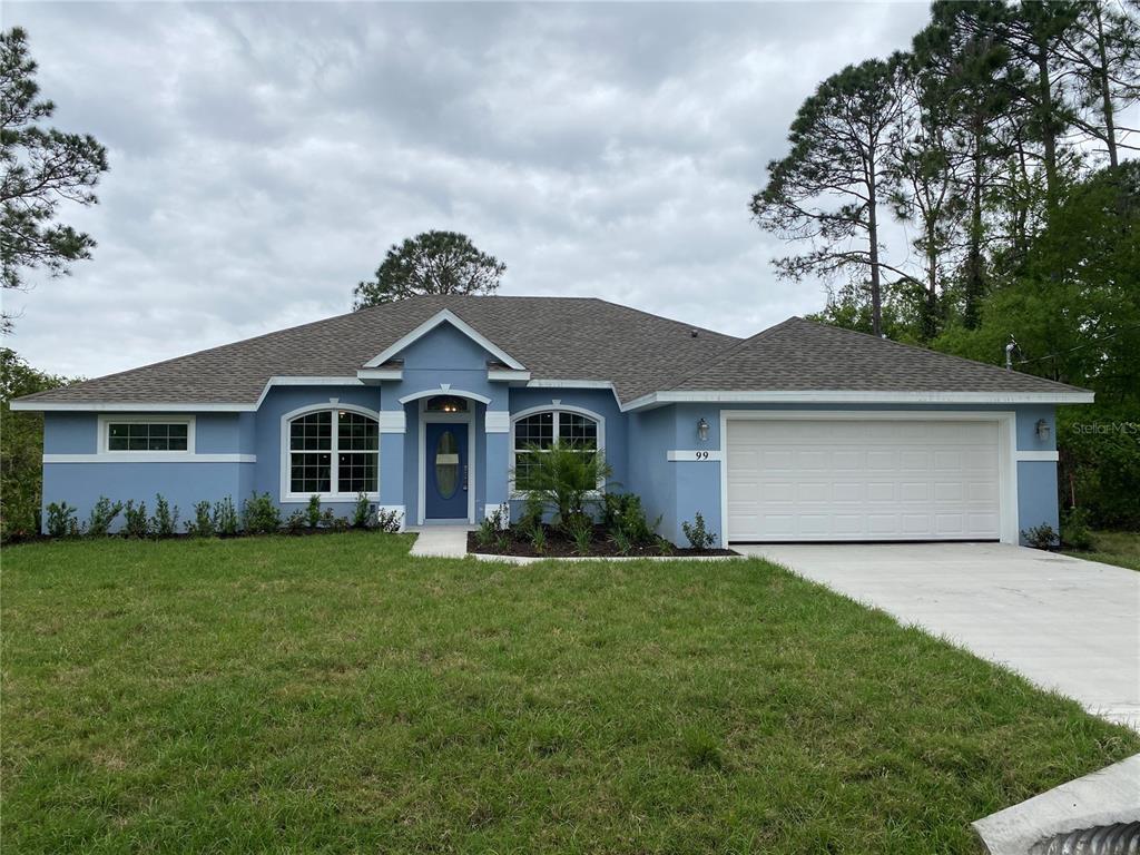 a front view of a house with a garden and yard