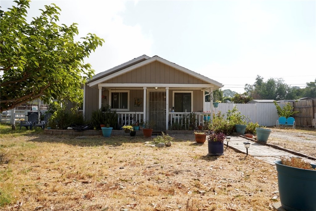 a front view of a house with a yard and seating space