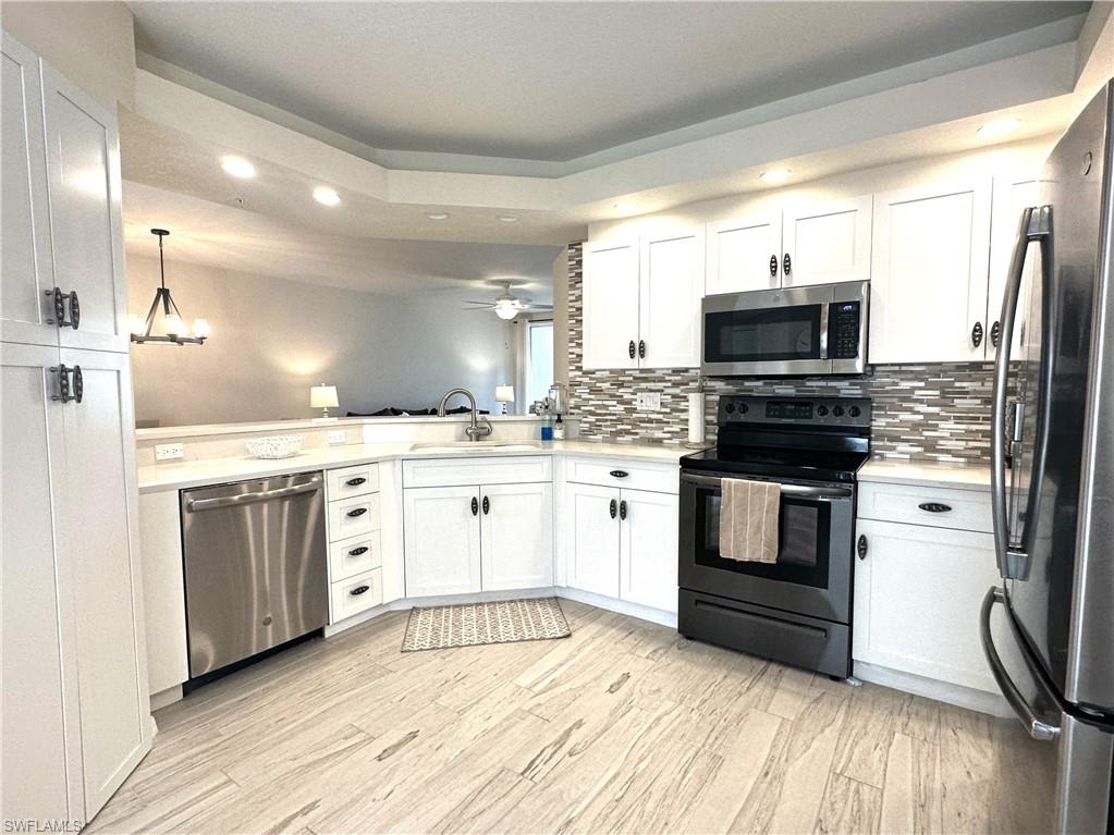 a kitchen with stainless steel appliances kitchen island granite countertop a stove a sink and a microwave