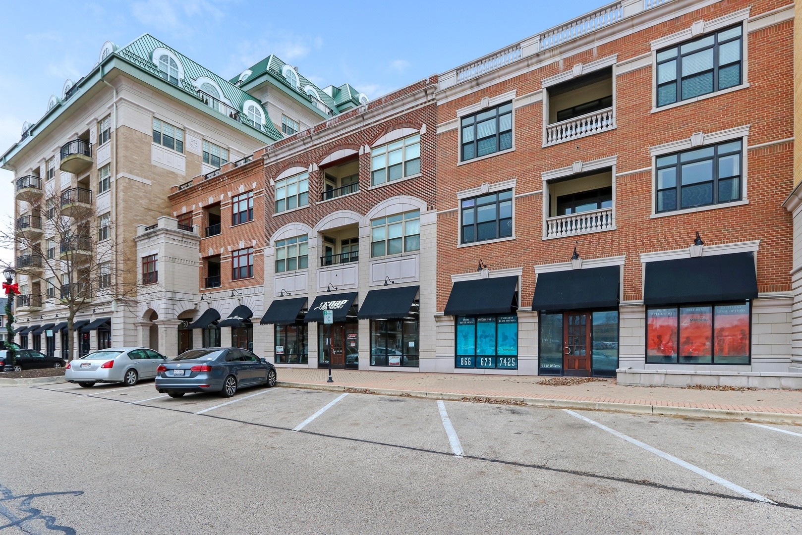 a couple of cars parked in front of brick building