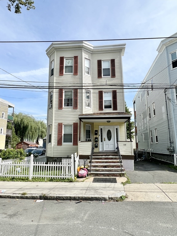 a front view of a house with a fence