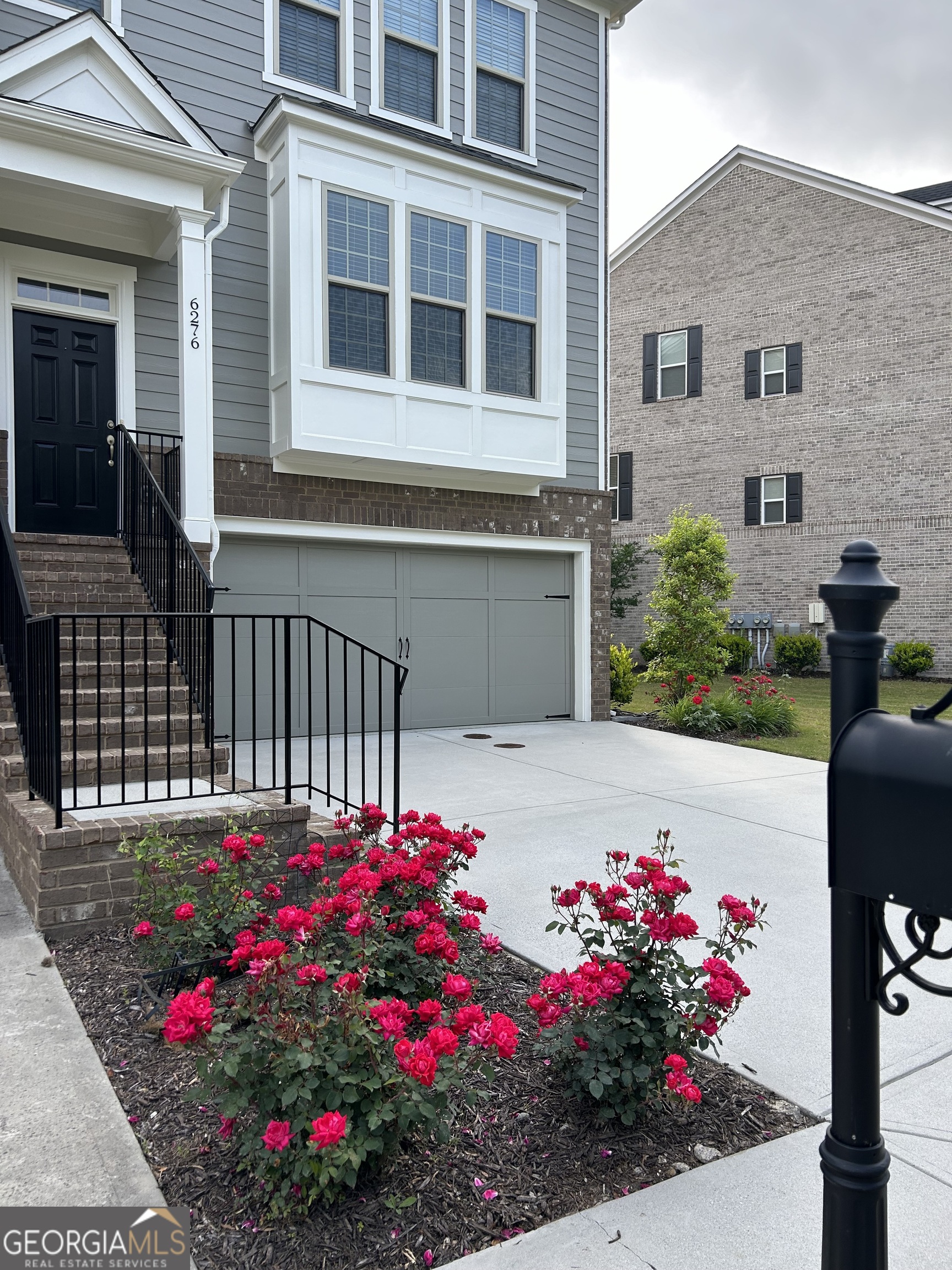 a view of a house with a flower garden