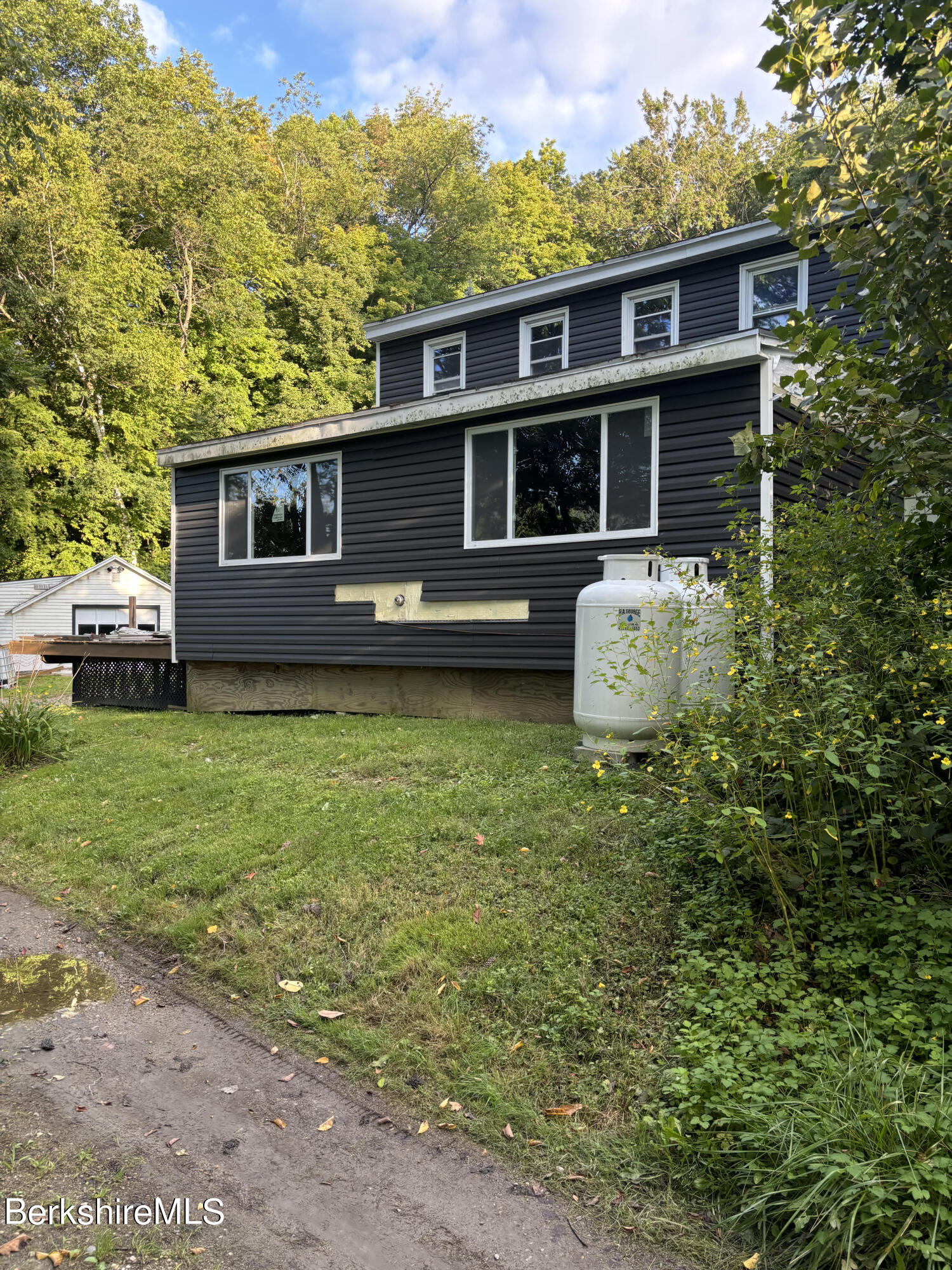 a front view of a house with a garden