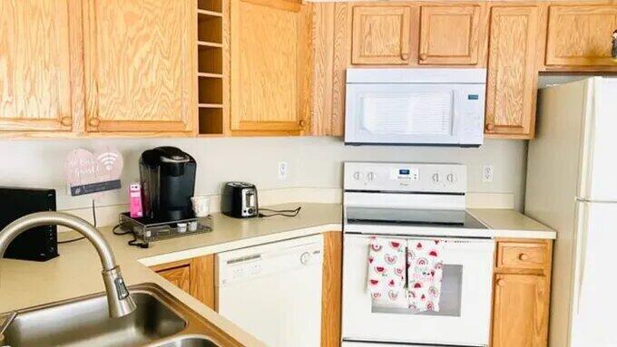 a kitchen with stainless steel appliances granite countertop a stove and a microwave