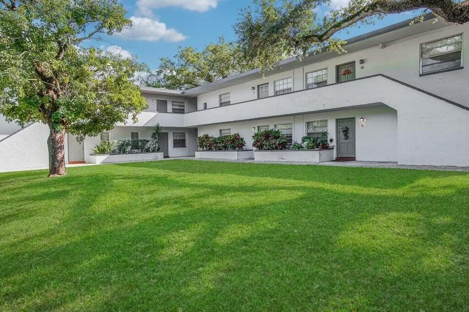 a view of house with yard and green space