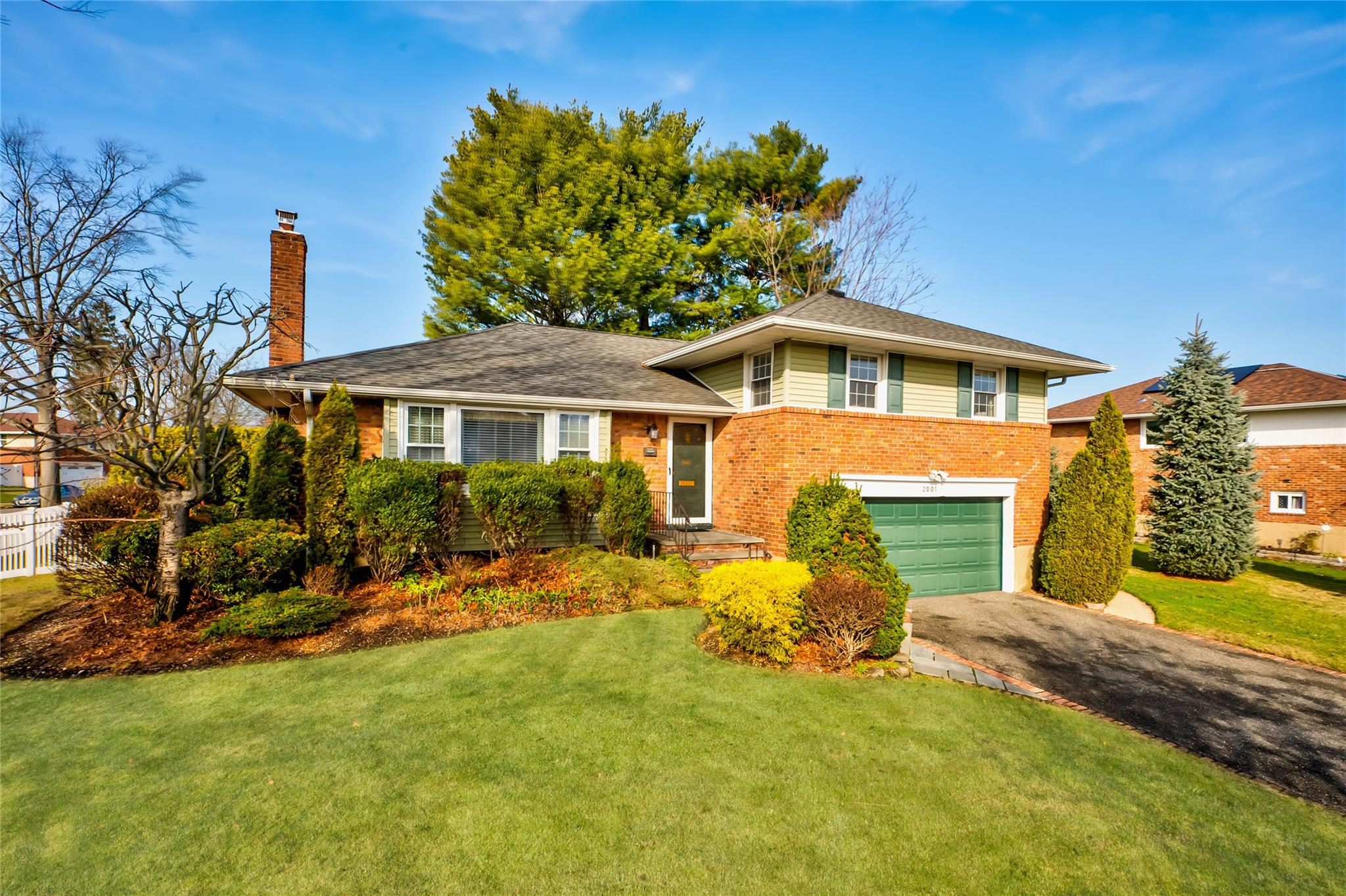 Tri-level home with a front yard and a garage