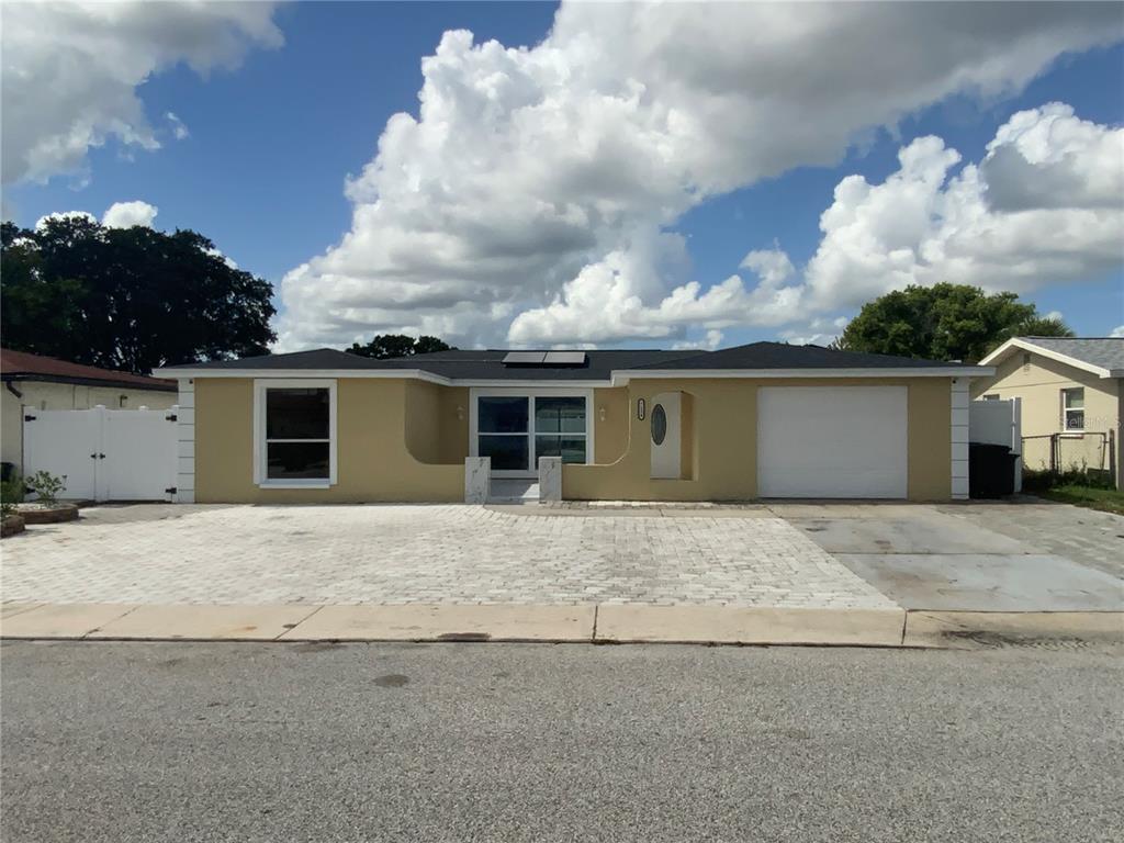 front view of a house with a yard and garage