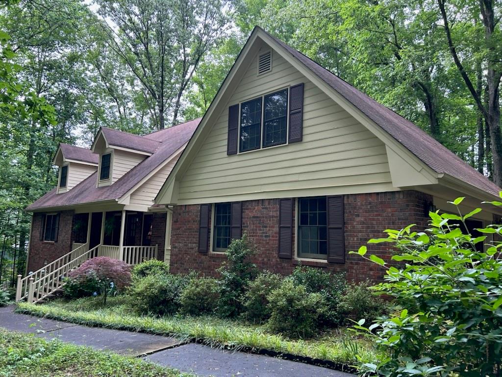 a front view of a house with a garden