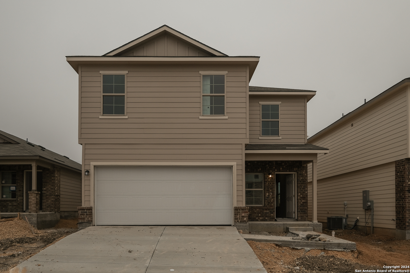 a front view of a house with garage