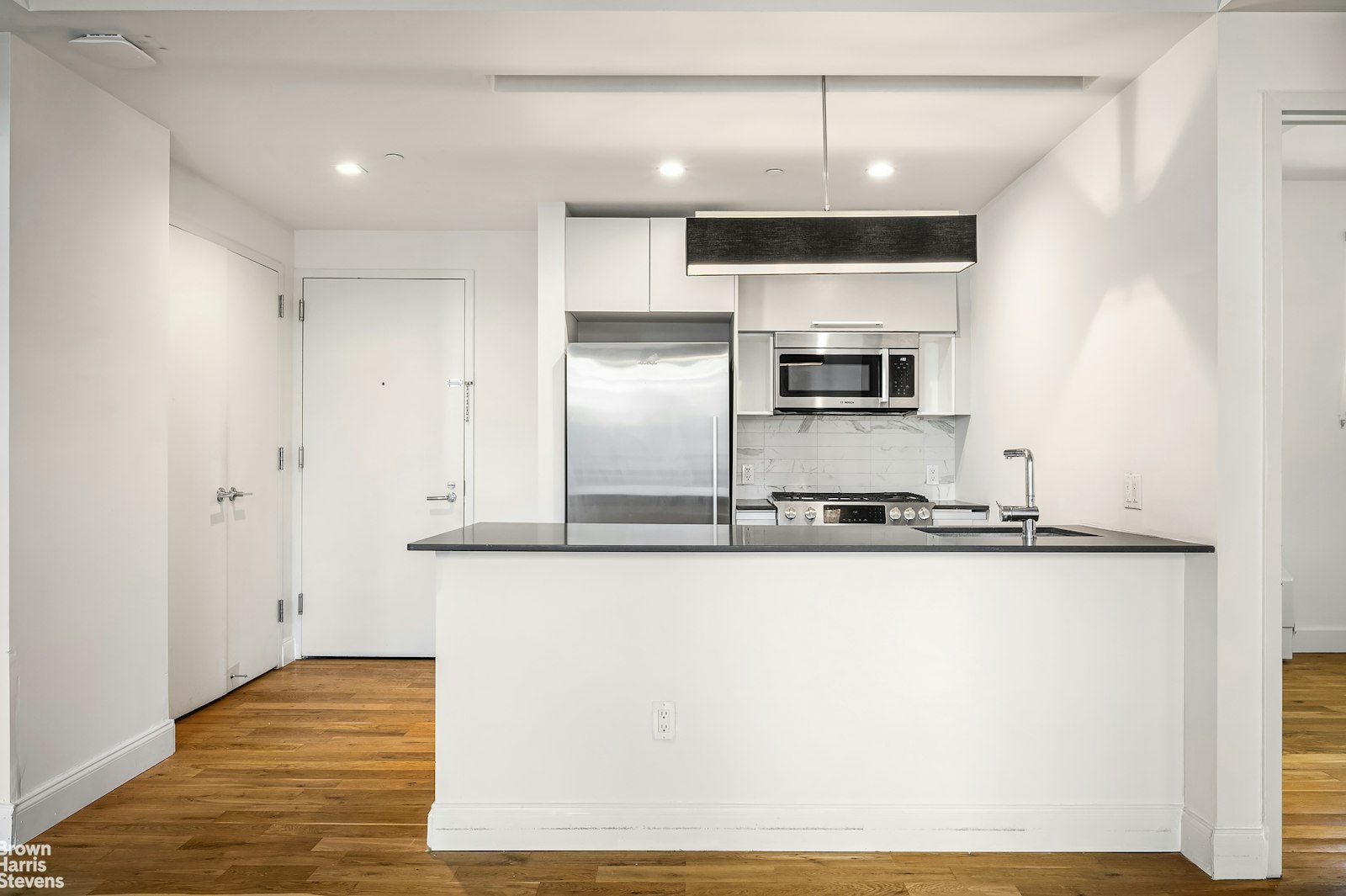 a kitchen with stainless steel appliances granite countertop a sink and a stove top oven