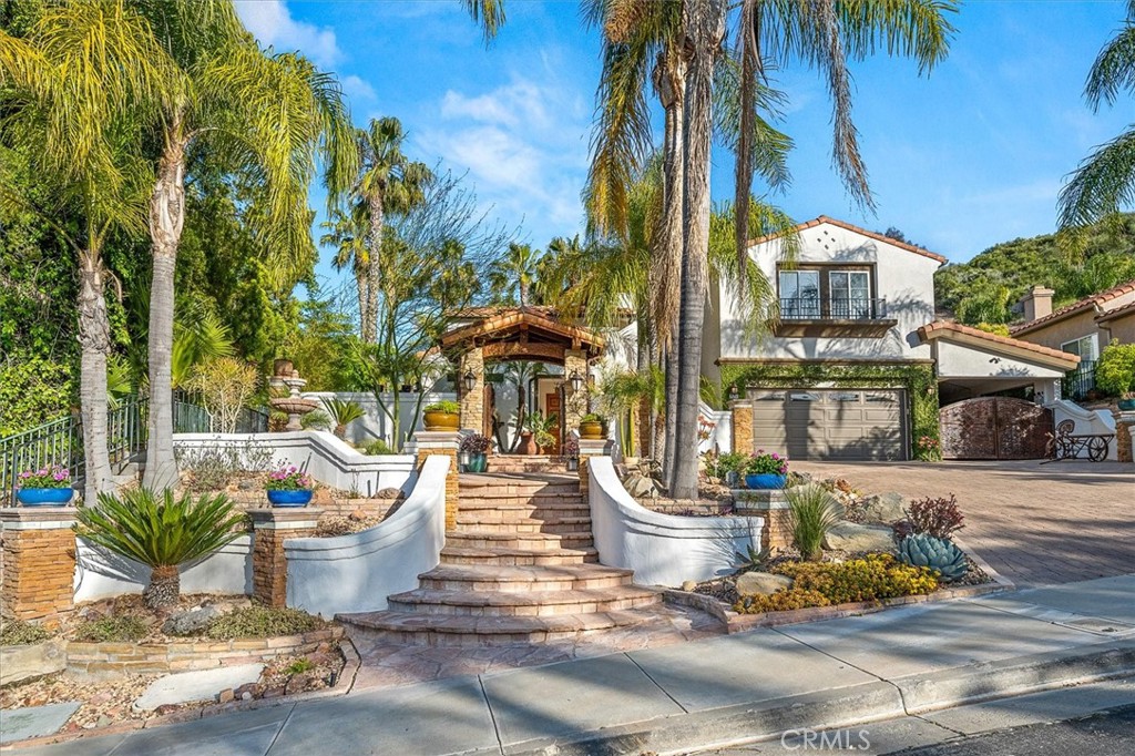 a view of a patio with table and chairs potted plants and palm tree