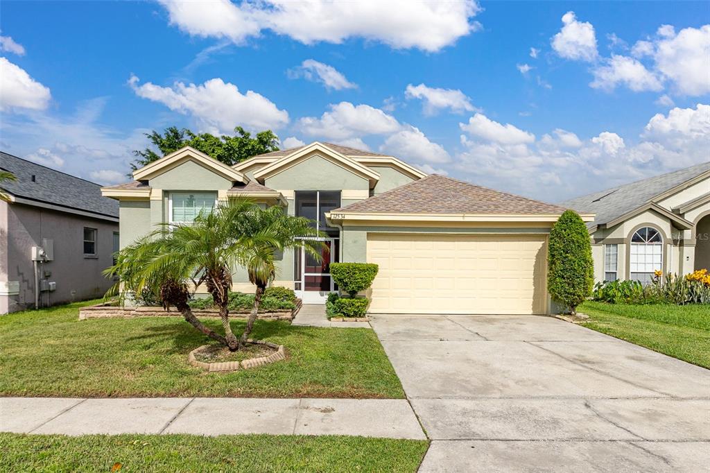 a front view of a house with a yard and garage