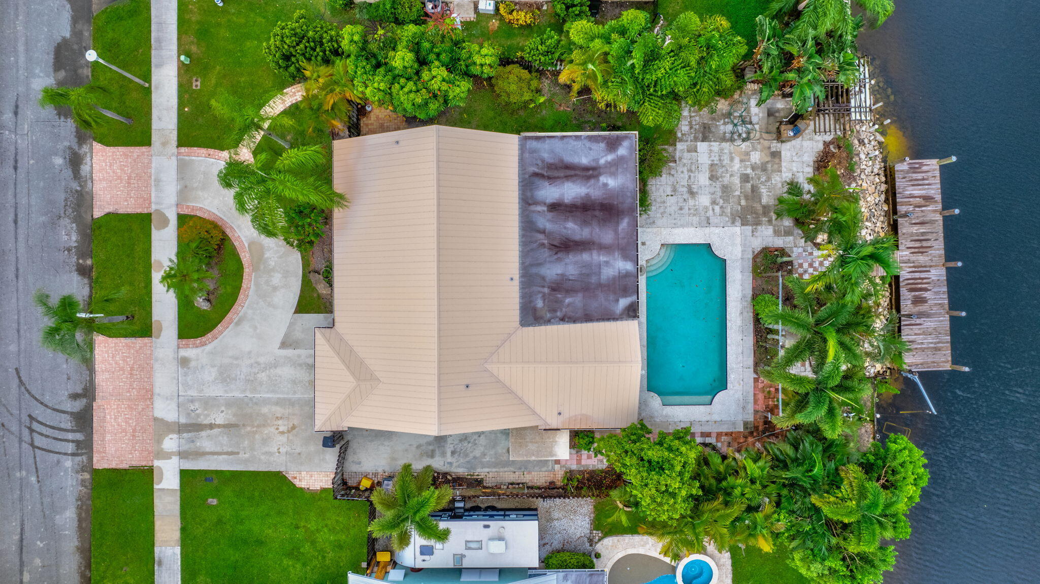 an aerial view of a house with a yard and garden