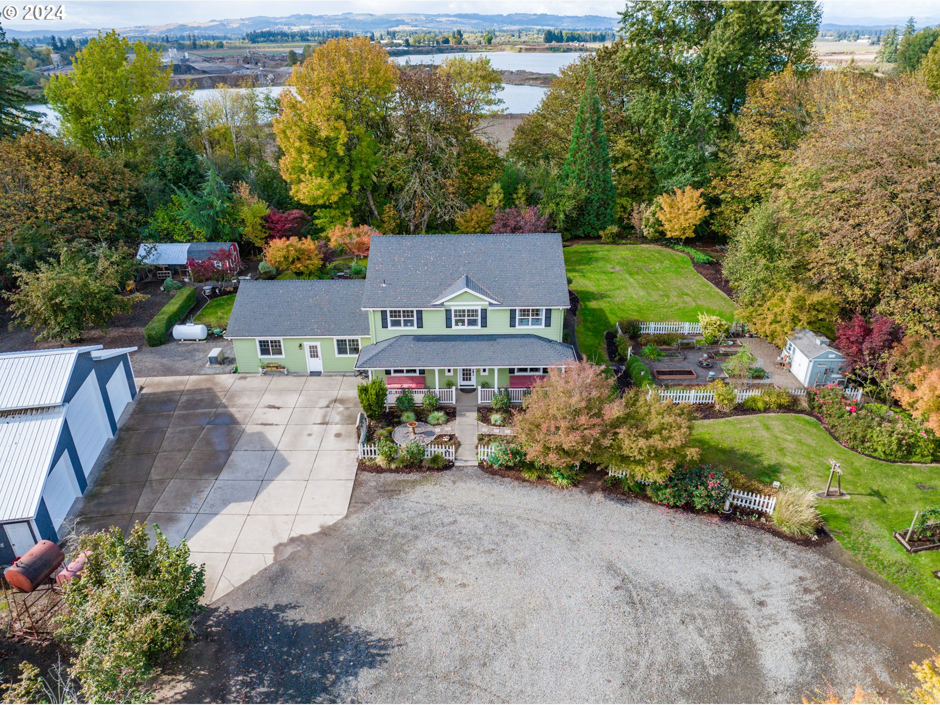 an aerial view of a house with garden space and street view