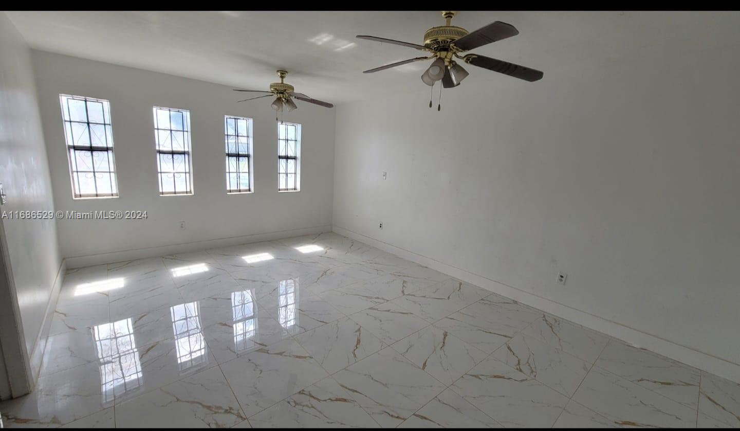 a view of a chandelier fan and windows