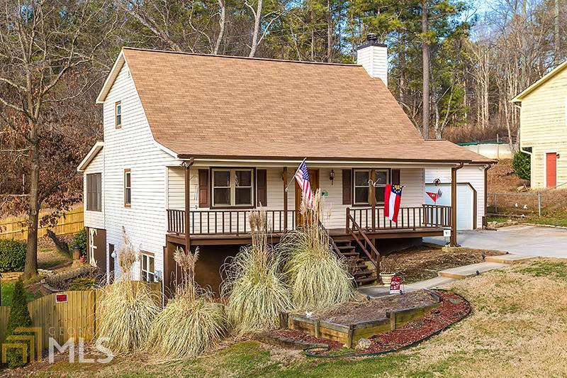 a view of a house with a fountain in a yard