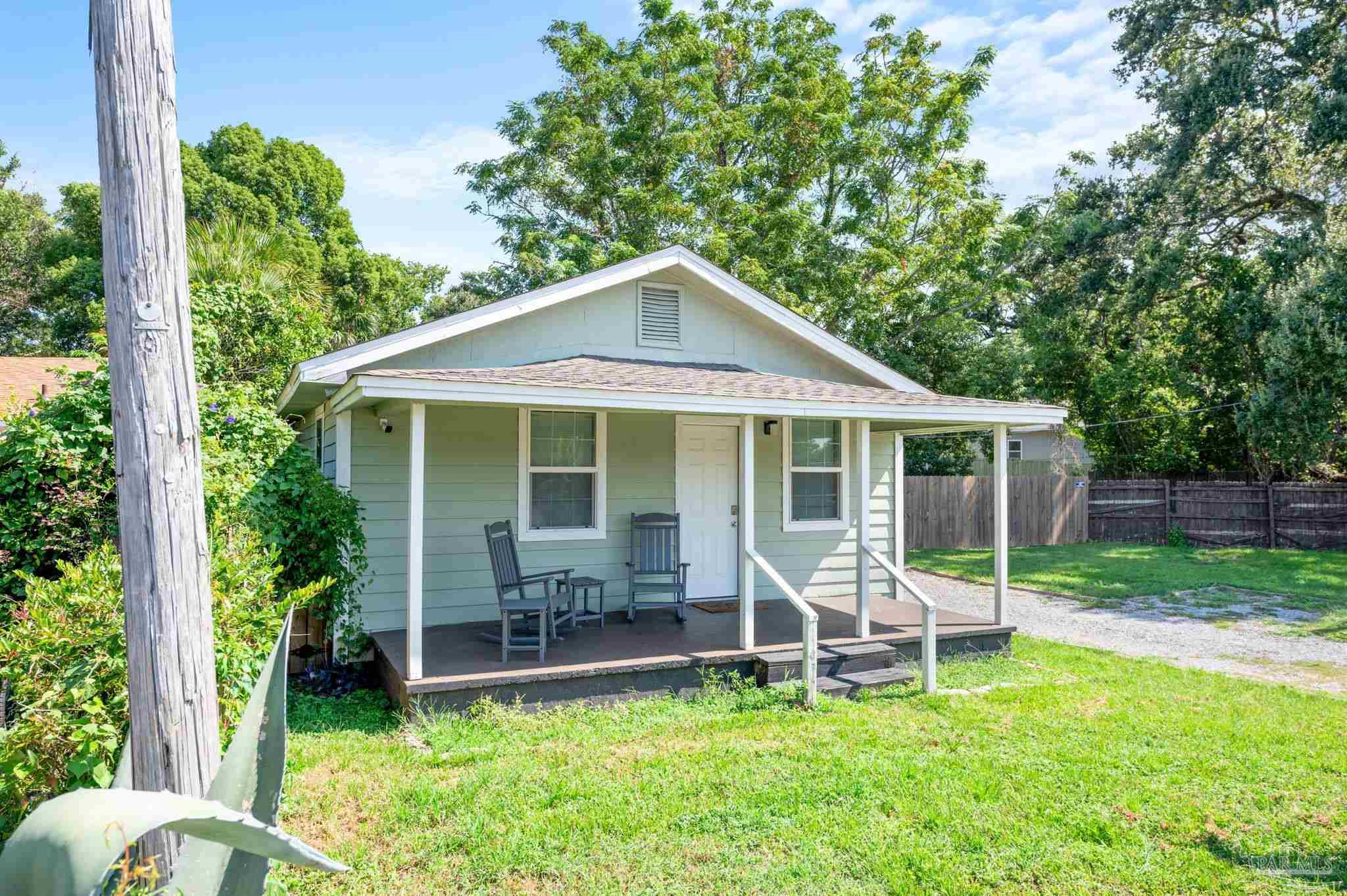 a backyard of a house with table and chairs