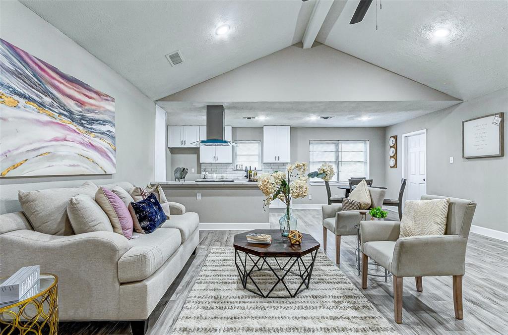 a living room with furniture kitchen and a table