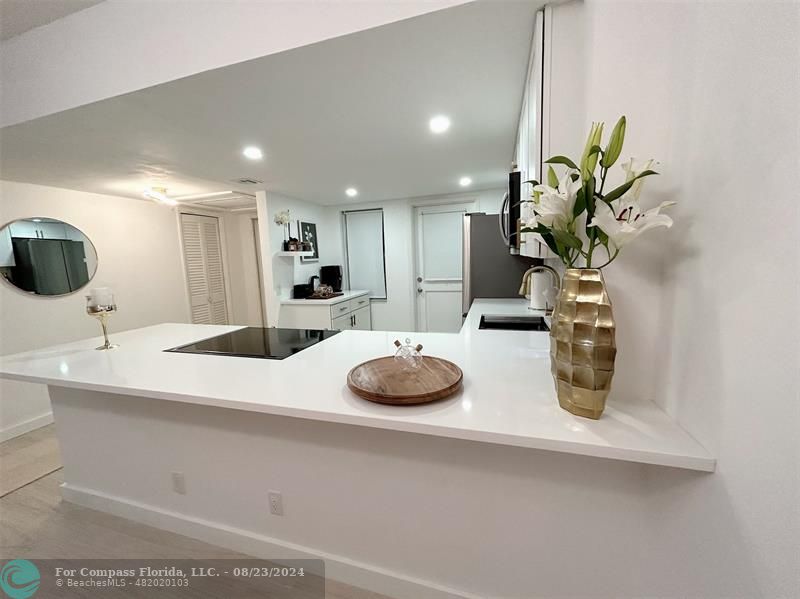 a bathroom with a sink a faucet a potted plant and a mirror