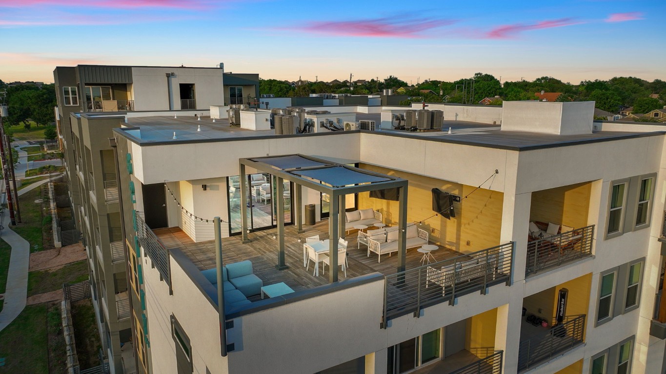 a view of a balcony with furniture and a kitchen