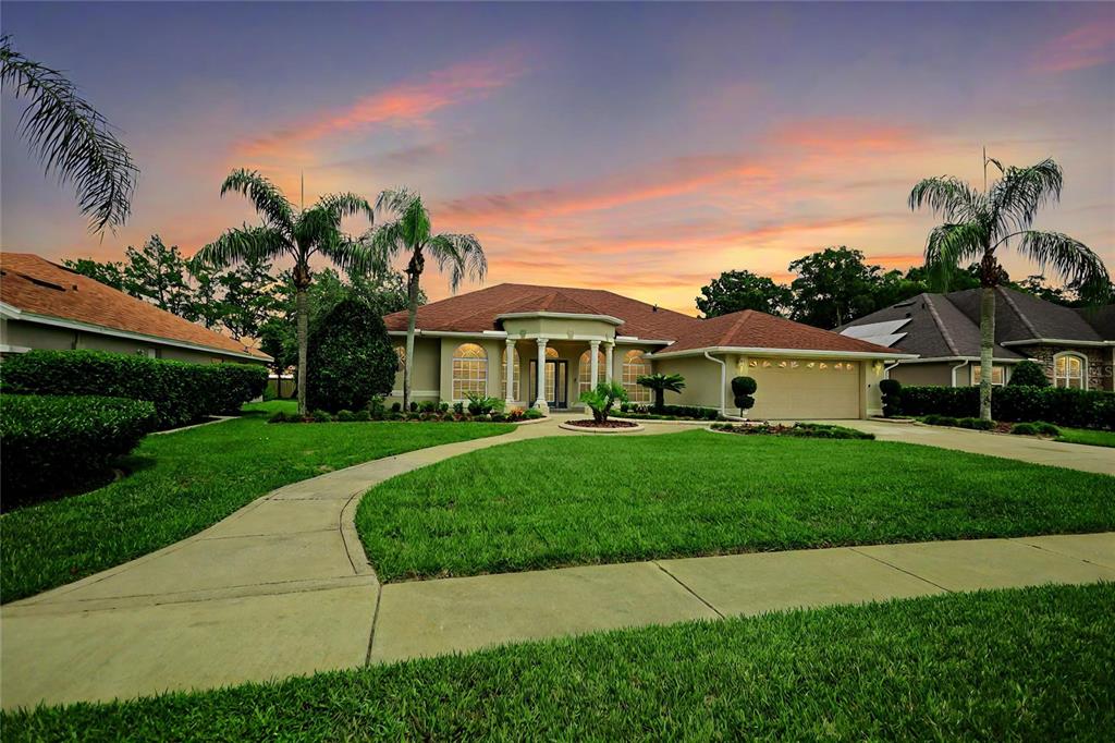 a front view of house with yard and green space