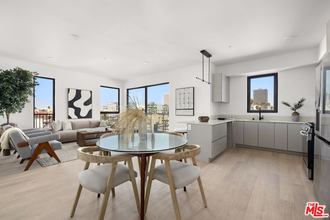 a living room with furniture a dining table and kitchen view