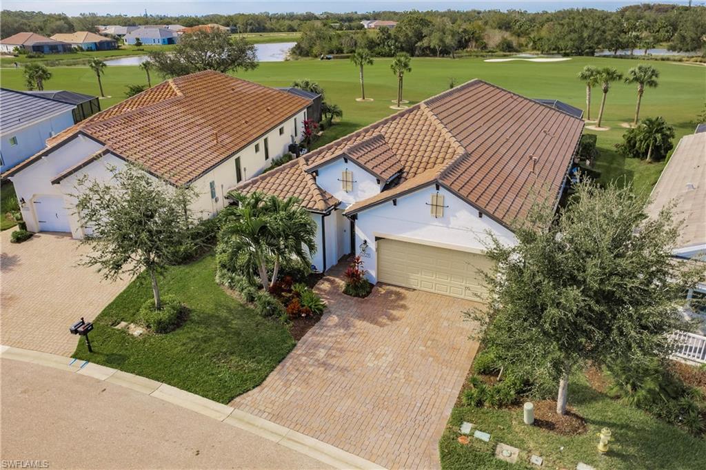 an aerial view of a house with a garden and lake view