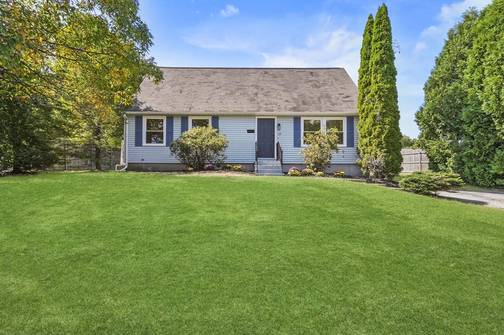 a front view of a house with a yard and porch