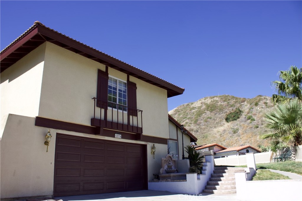 a front view of a house with mountain view