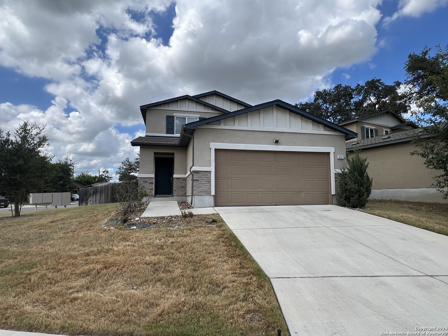 a front view of a house with a yard