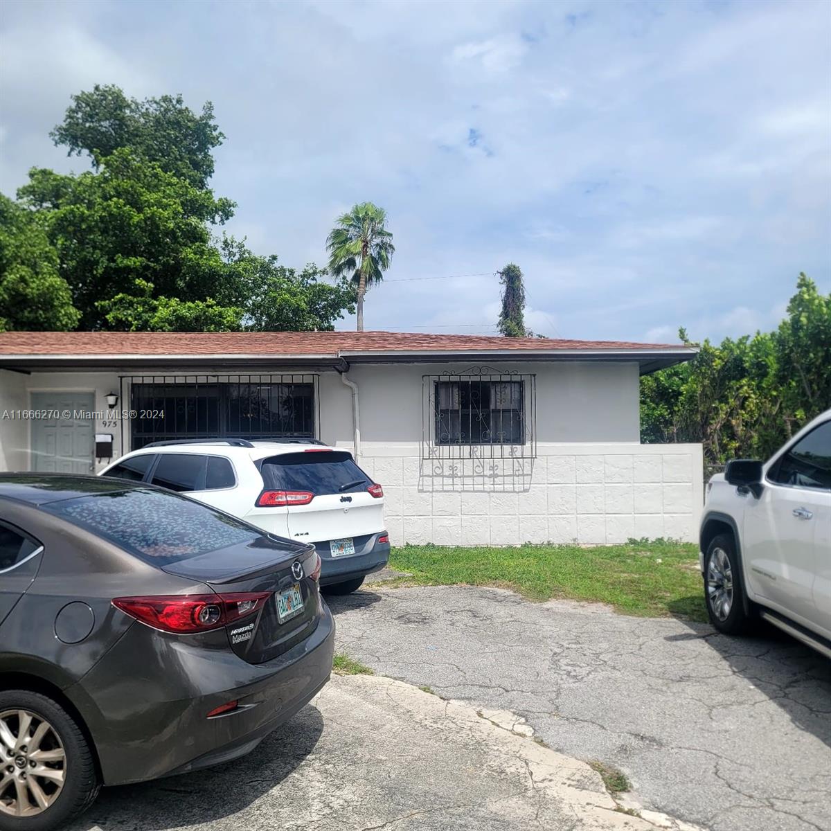 a front view of a house with parking space