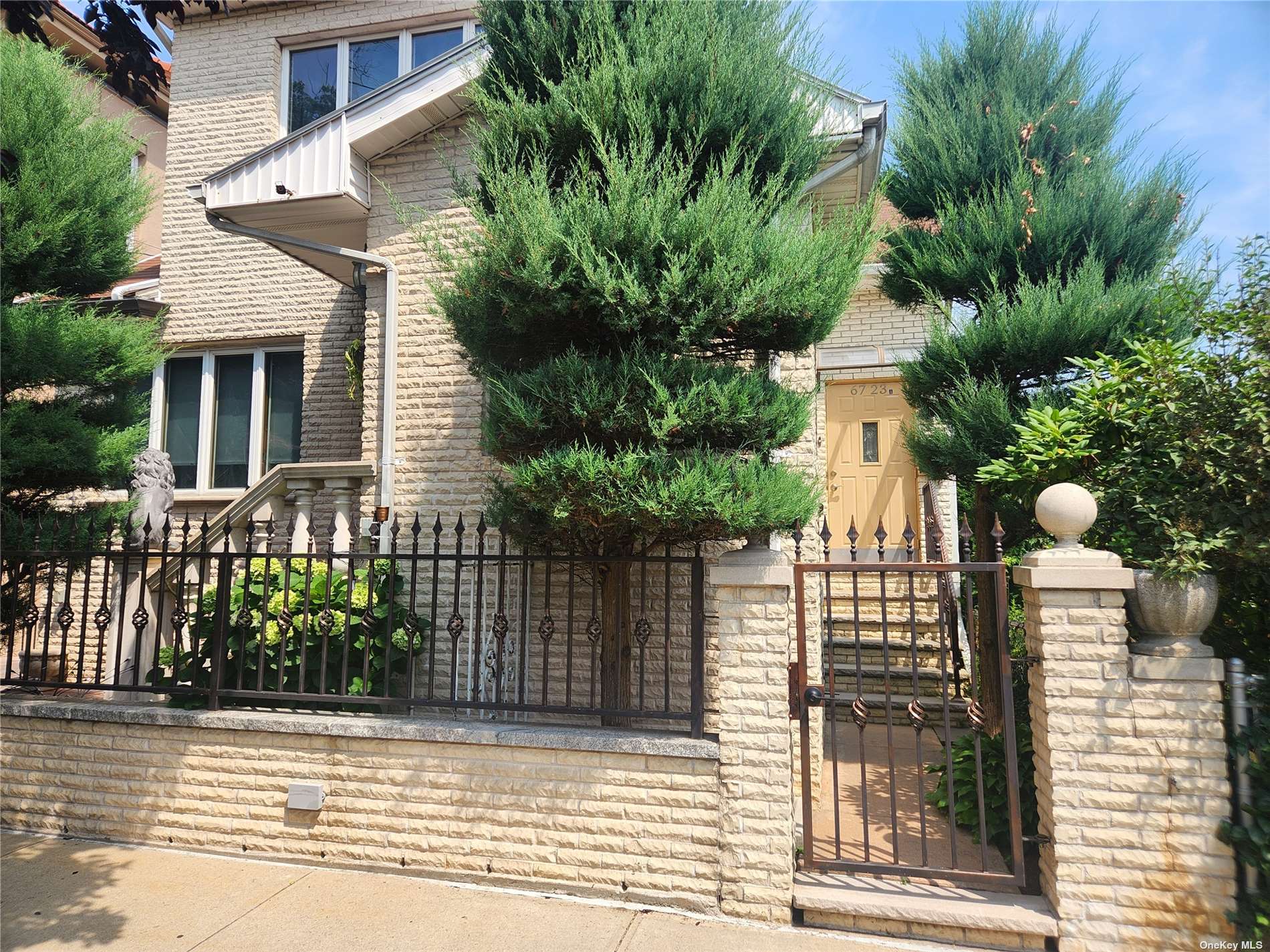 a front view of house with a garden