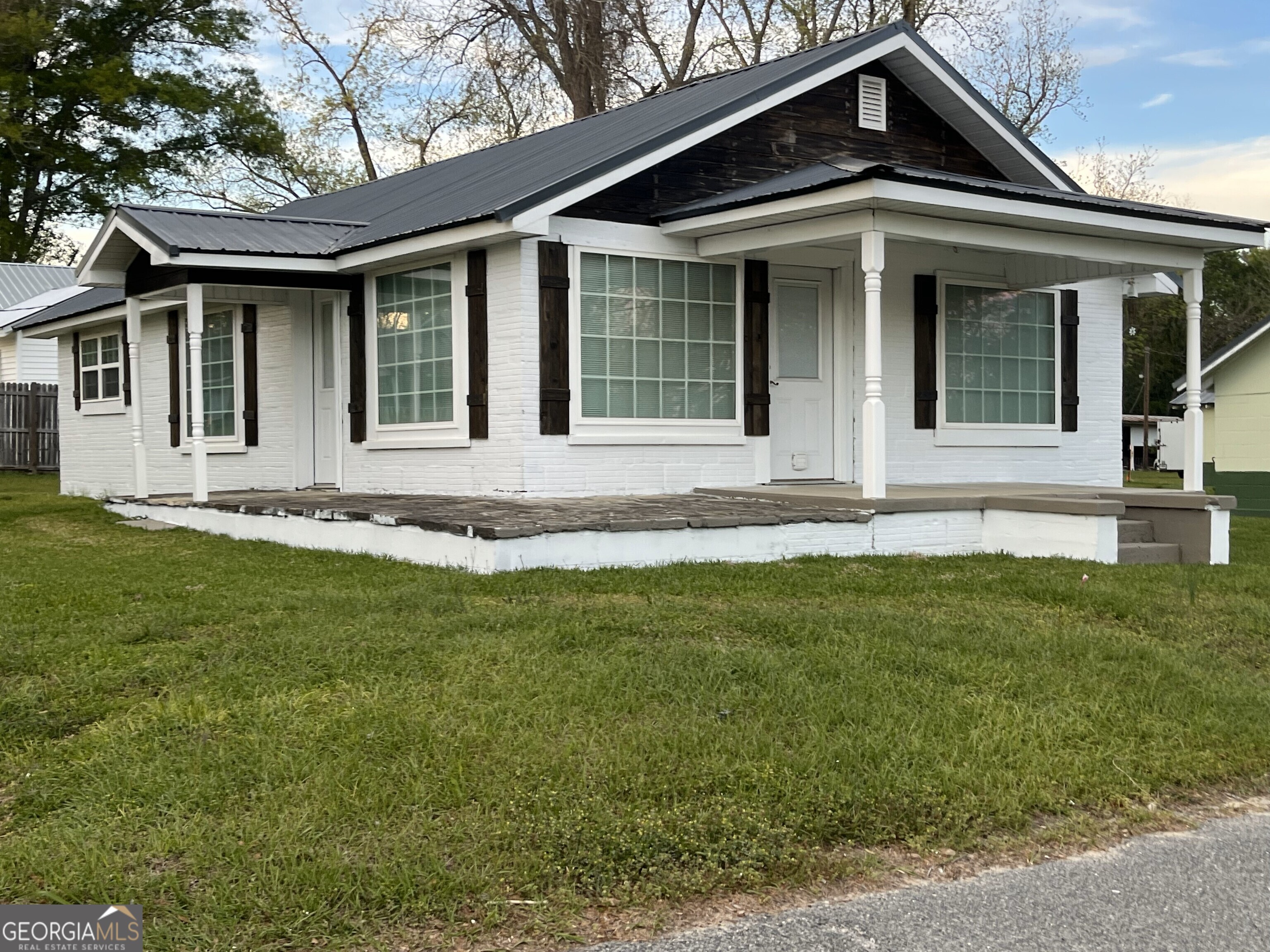 a front view of a house with a garden