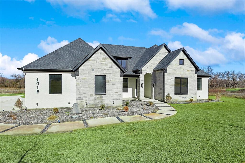 a front view of house with yard outdoor seating and barbeque oven