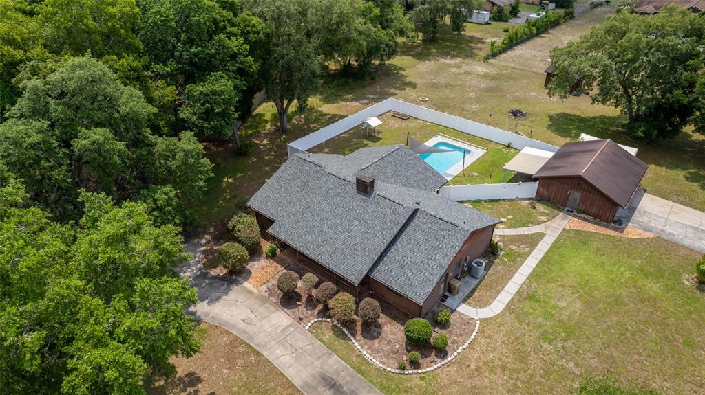 an aerial view of a house having swimming pool