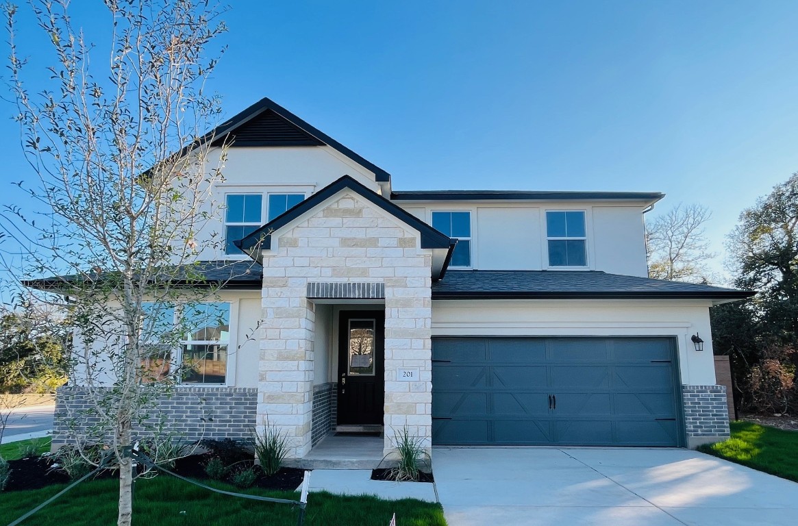 a front view of a house with garage