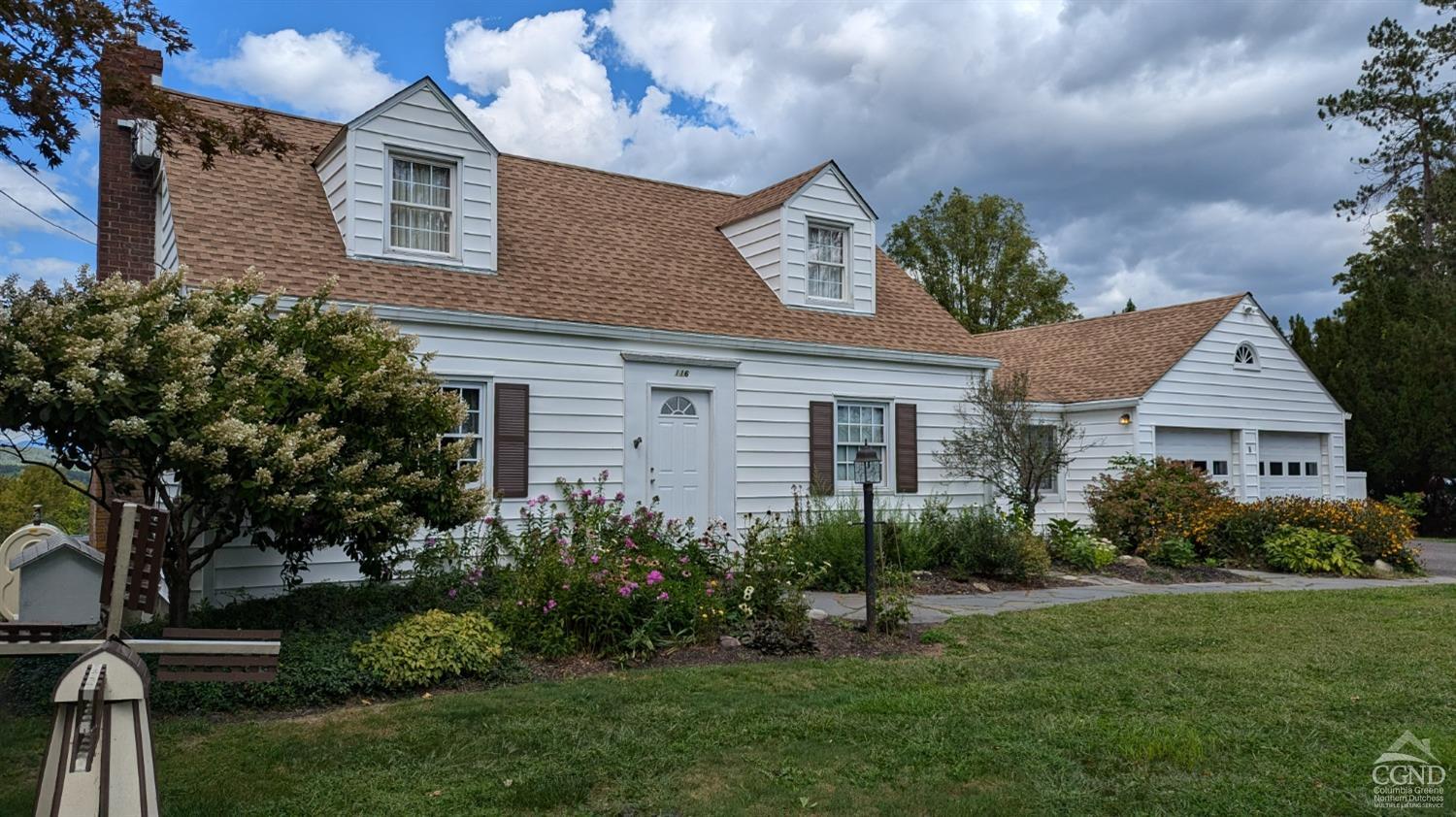 a front view of house with yard and green space