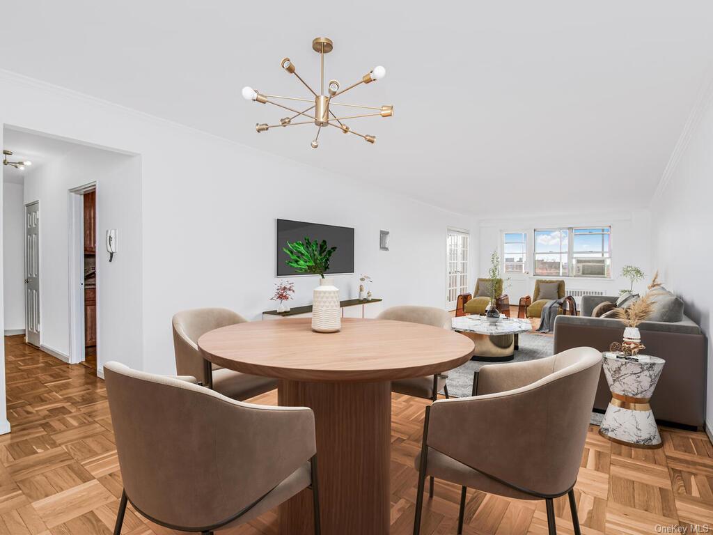 Dining area with parquet flooring, ornamental molding, and an inviting chandelier