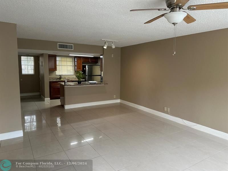 a view of a kitchen with a sink cabinets and a ceiling fan