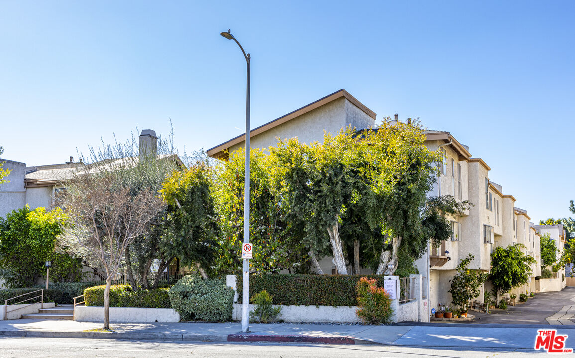 a front view of a building with tree s