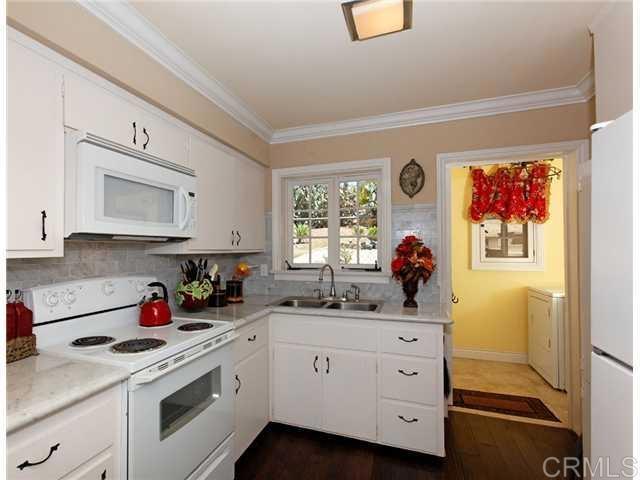 a kitchen with cabinets appliances and a window