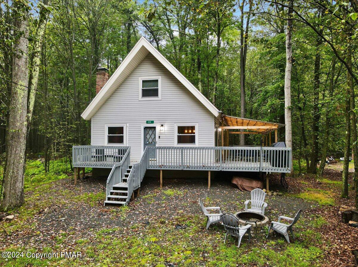 a view of a house with a yard chairs and a patio