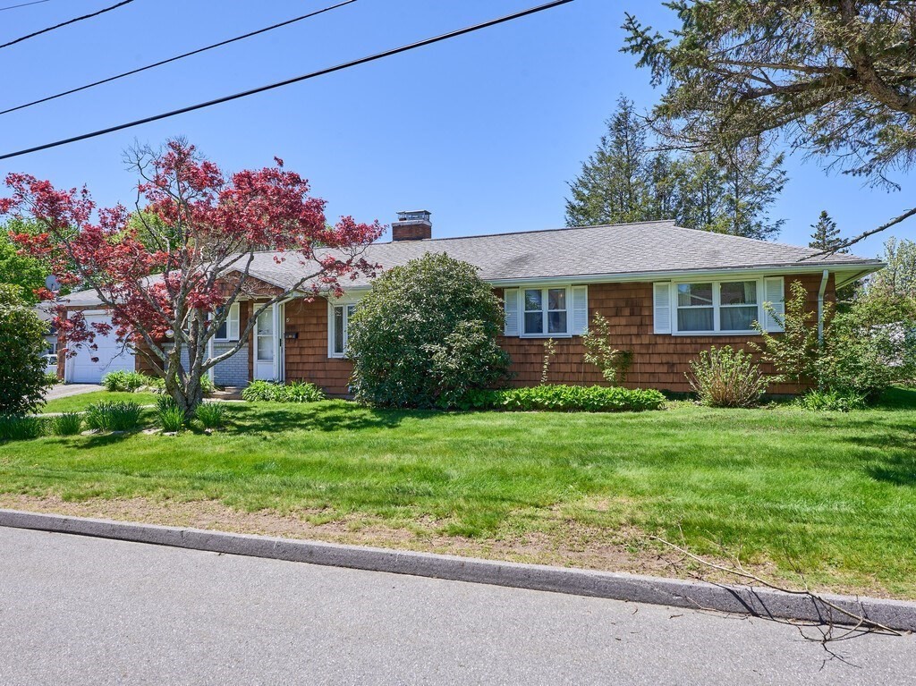 a front view of a house with a garden