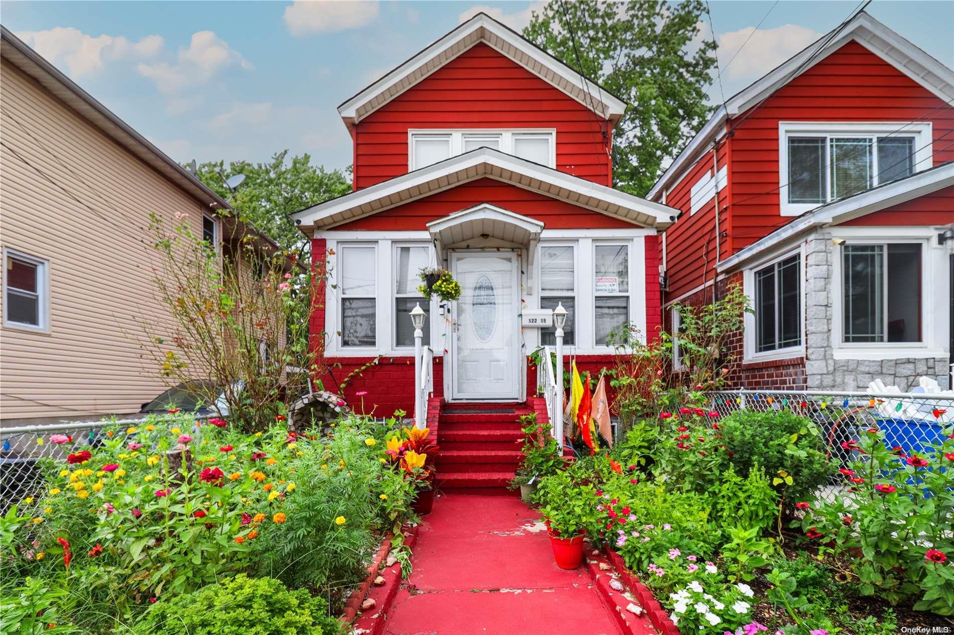 a front view of a house with a yard and fountain